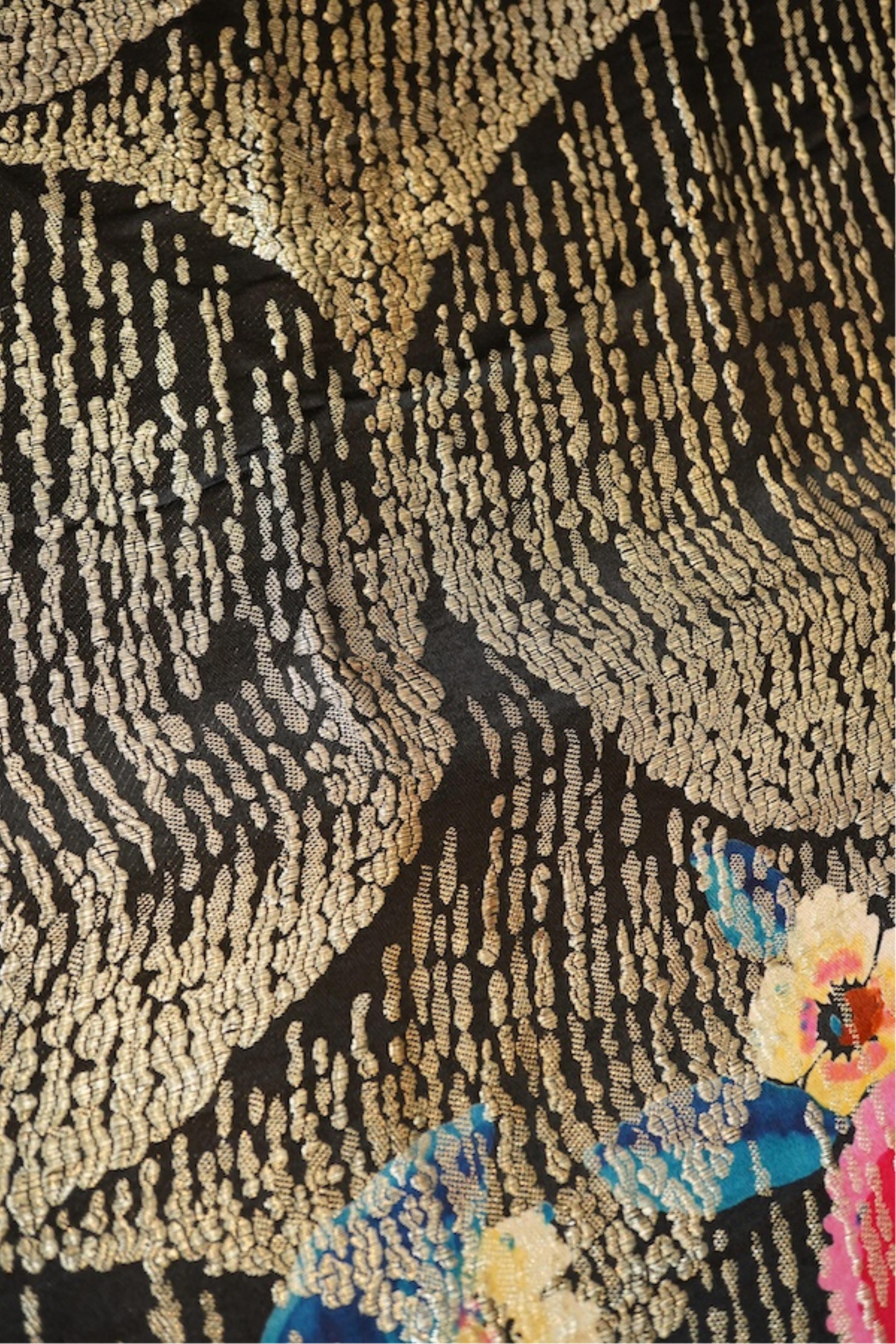 A 1930's ‘jazz age’ black and coloured silk lame evening shawl. Woven with giant pink and red roses and silver thread stripes, edged with long silk fringing. 118cm x 123cm. Condition - colours and silk strong. Fringing g
